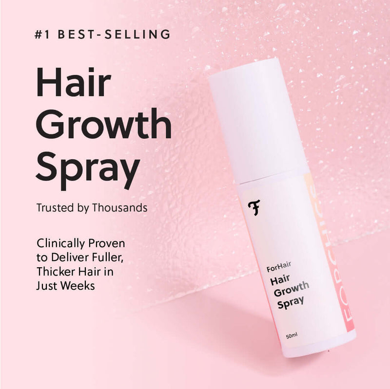 Hair growth spray bottle on a pink textured background with product description.